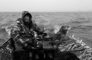 Ben Mott and Grizzly in boat