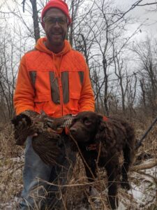 A LTH participant with his first ruffed grouse with Aldo, Warden Otto’s American Water Spaniel. Aldo flushed it and retrieved it.